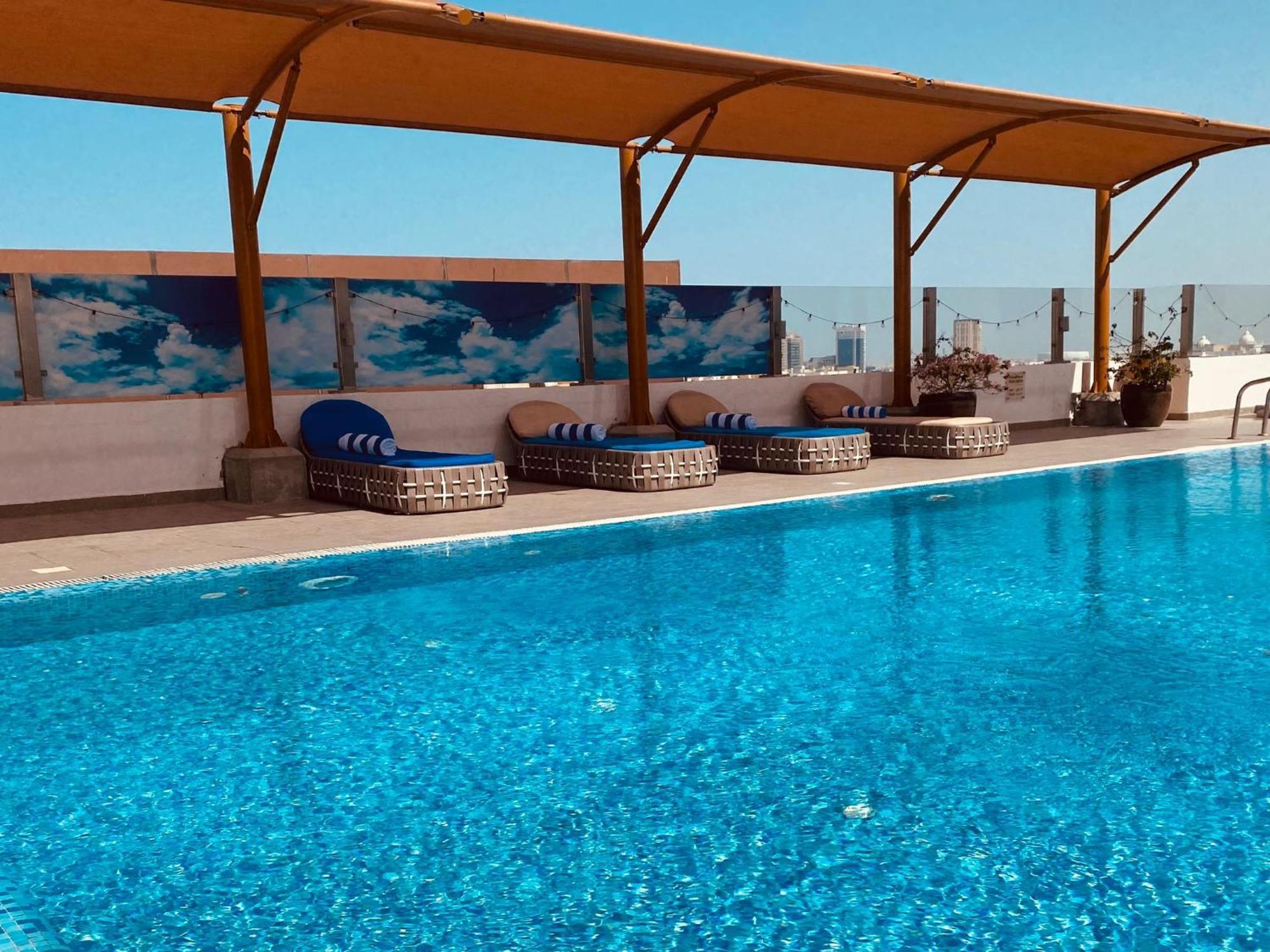 The Avenue Hotel Doha Exteriör bild Rooftop pool at the hotel